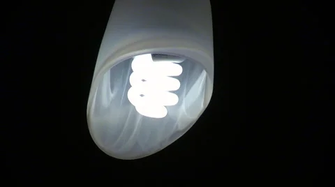 Fluorescent light bulb in a dark room flashing on and off Stock Footage 68386850