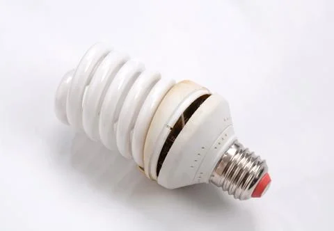 Fluorescent Lightbulbs. One compact old fluorescent light bulb over on white  Stock Photos