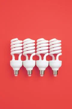 Fluorescent Lightbulbs on a red background. Stock Photos