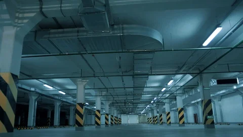 Fluorescent lights flicker and light up and illuminate underground parking Stock Footage