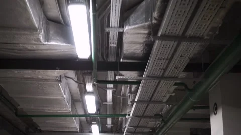 Fluorescent lights flicker. Footage. light up and illuminate a large underground Stock Footage 131029617