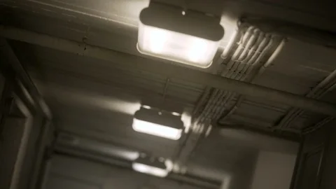 Fluorescent Lights Flicker on in a Hallway Stock Footage 94560482