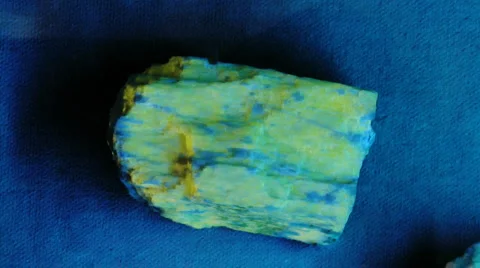 Fluorescent rock under UV and white light Stock Footage 1847736