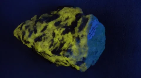 Fluorescent rock under UV and white light Stock Footage 1847896
