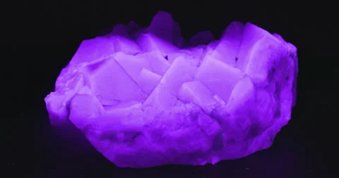Fluorite Crystal Glowing under UV Light Stock Footage 329294399