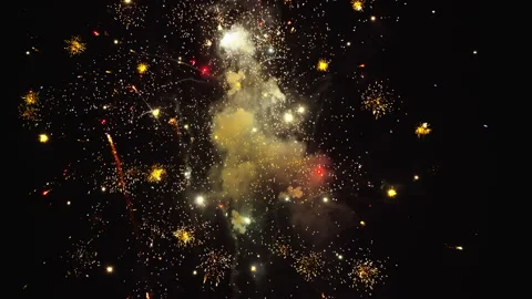 Flurry of fireworks explode in slow motion at nighttime fireworks show Stock Footage 248084976