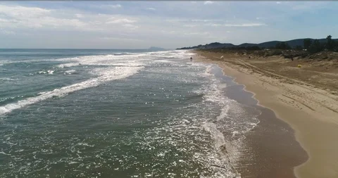 Flush drone flight over the waves of Mediterranean golden beach Stock Footage 124374627
