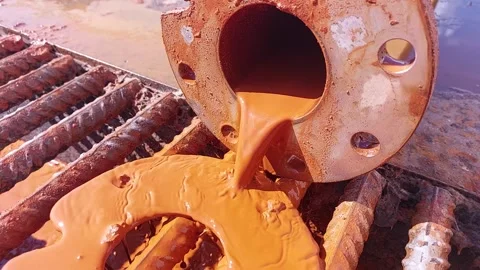 Flushing a Pipe With Rust in the City at Noon Stock Footage 345365123