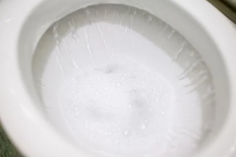 Flushing toilet after using it Stock Photos