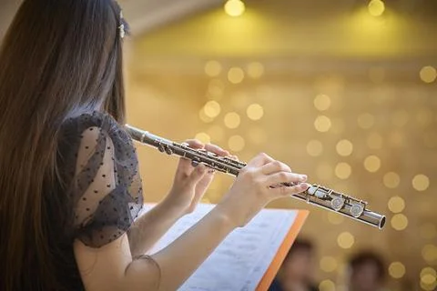 Flute Player Practicing with Sheet Music in Concert Hall. Copy space Stock Photos