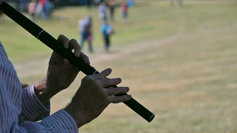 Flute Player Under Shade at a Fall Festival. Stock Footage 217405565