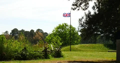 A Fluttering Red and Blue Flag in a Clear Sky Stock Footage 240689639