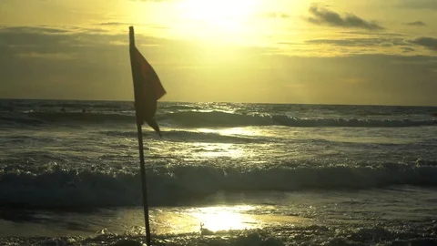 Fluttering Red Flag On The Stormy Day At Sea Beach Sunset Bali 4k Stock Footage 104538115