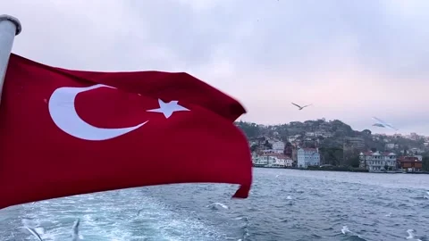 The fluttering of the Turkish flag against the backdrop of the Bosphorus Stock Footage 202114319