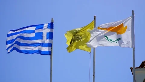Fluttering in wind flags of Cyprus and Greece against blue sky, slow motion Stock Footage 107551937