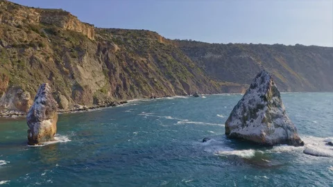 Fly above  blue sea surface rocks. Stock Footage 128696256