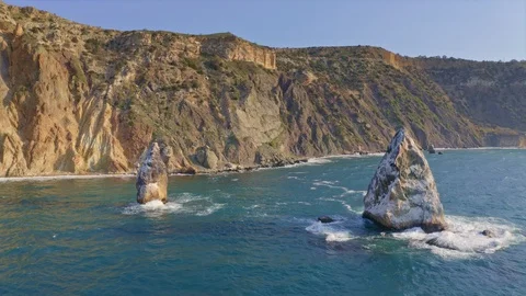 Fly above  blue sea surface rocks. Stock Footage 128696260