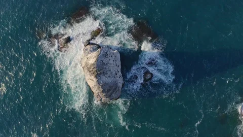 Fly above  blue sea surface rocks. Stock Footage 128696319