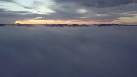 Fly above the clouds during sunrise. Stock Footage 80000978