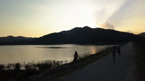 Fly up above a lake at sunset time in Chiang Mai, Thailand Stock Footage 100799329