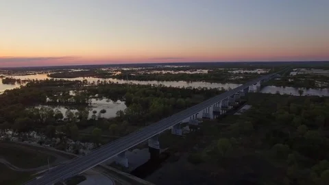 Fly above river overflowed its banks and bridge road in flooded area aerial 4k Stock Footage 77909745