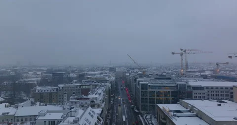 Fly above wide boulevard with queue of cars. Friedrichstrasse in winter. Hazy Stock Footage 166930226