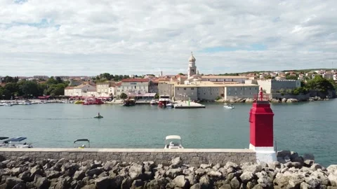 Fly across Lighthouse on Blue Bay Island Krk Croatia to Old City Stock Footage 232616229