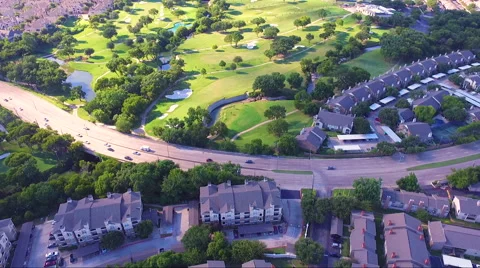 Fly Across Road Between Apartment Complex And Golf Course Stock Footage 65795344