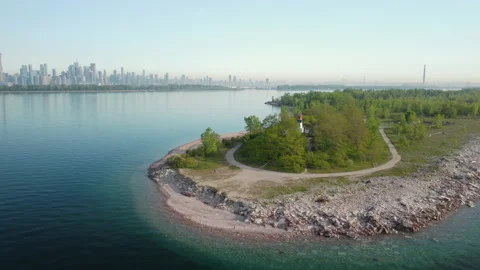 A fly-by aerial of Lighthouse Point featuring the Toronto city skyline Stock Footage 155210316