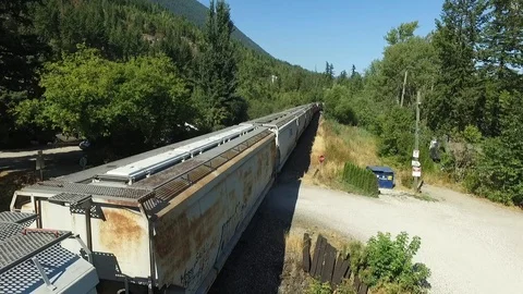 Fly Along side train with lake reveal Stock Footage 87796416