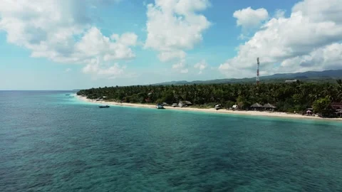 Fly along white sand beach small tropical island Stock Footage 165773334
