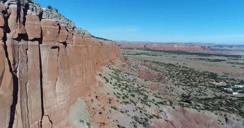 Fly alongside massive red rock cliffs Stockbeeldmateriaal 84329216