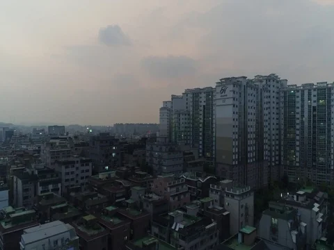Fly in, and flyover of tall apartments in Seoul at dusk Stock Footage