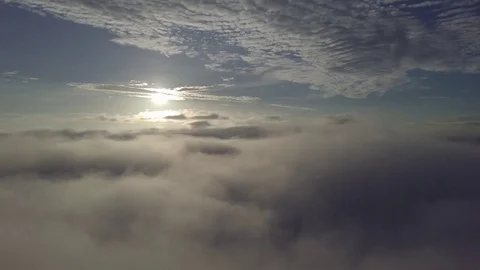 Fly and panning, above the clouds during sunrise. Stock Footage 80017055