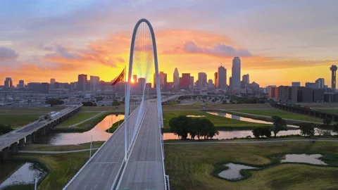 Fly arc Left with Dallas skyline, famous bridge and Flag at sunrise-NICE! Stock Footage 156348458