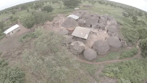Fly around an African household during the wet season original color Stock Footage 84073196