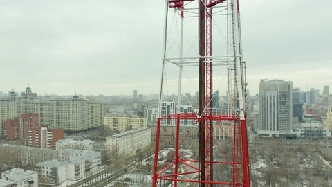 Fly-around around a large area of a large telecommunications tower with view of Stock Footage 165347499