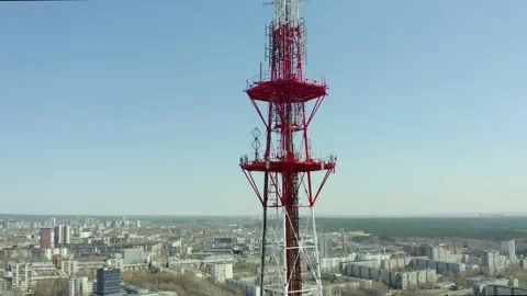 Fly-around around a large area of a large telecommunications tower with view of Stock Footage 165349346