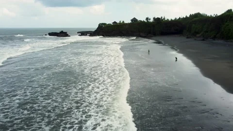 Fly around black sand beach before storm in Bali Stock Footage 157905372