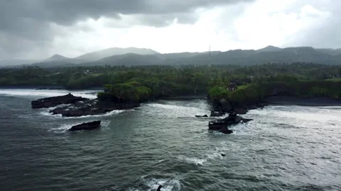 Fly around black sand beach before storm in Bali Stock Footage 157905723