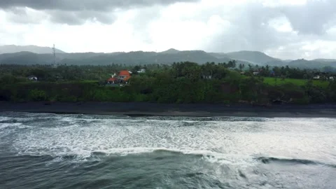 Fly around black sand beach before storm in Bali Stock Footage 158097277