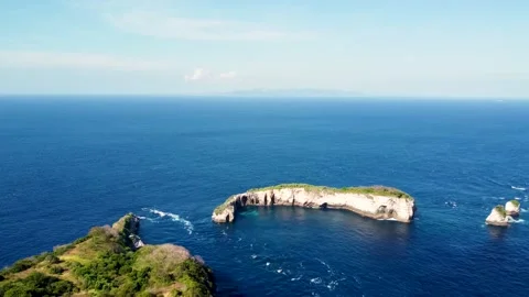 Fly around cliff and rocks over ocean along coast Stock Footage 161783299