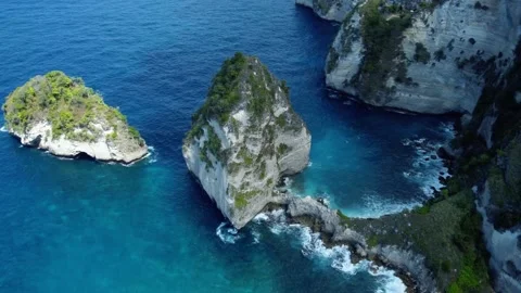 Fly around cliff and rocks over ocean along coast Stock Footage 161783335