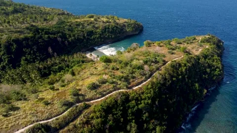 Fly around cliff and rocks over ocean along coast Stock Footage 162568776