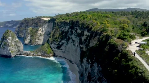 Fly around cliff and rocks over ocean along coast Stock Footage 162569707