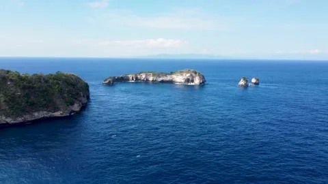 Fly around cliff and rocks over ocean along coast Stock Footage 163366485