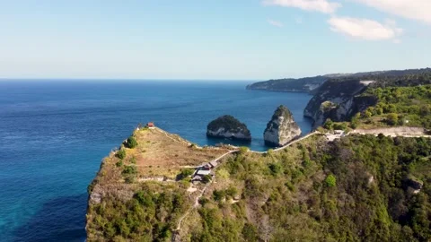 Fly around cliff and rocks over ocean along coast Stock Footage 163366561