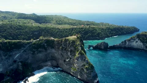 Fly around cliff and rocks over ocean along coast Stock Footage 165844849