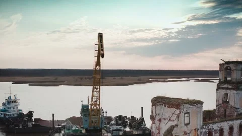 A fly-around of the crane boom working on the restoration of the old lighthouse Stock Footage 218404078