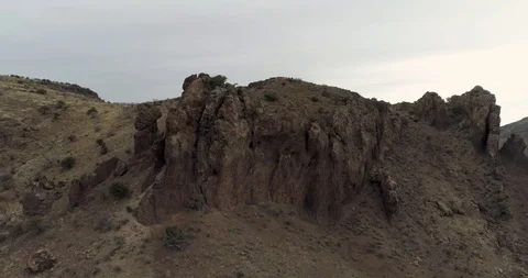 Fly around dramatic rock towers formed from volcano drone aerial 4K Stock Footage 111315940
